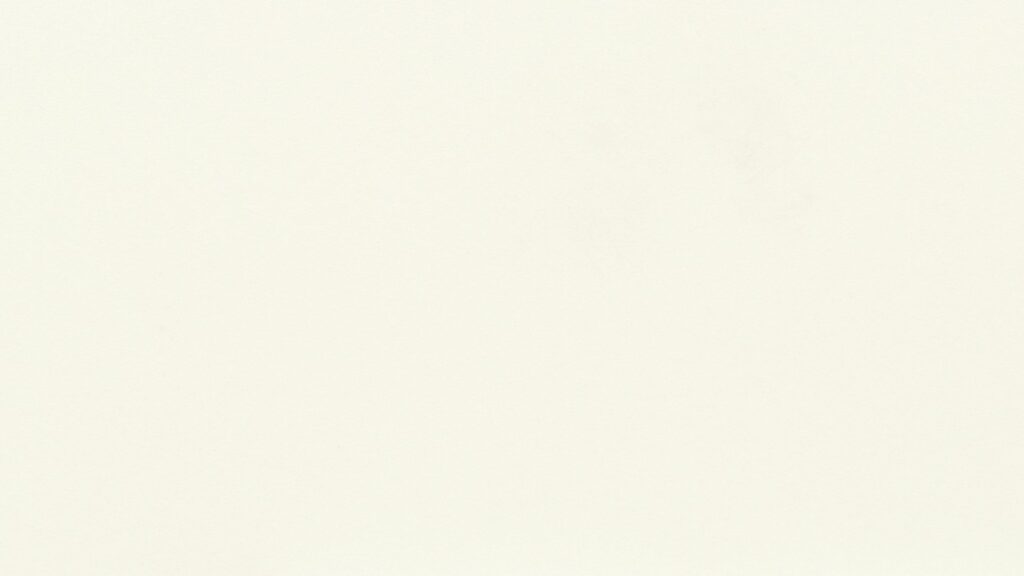 An image of a blank, off-white surface with a smooth texture and subtle shadowing.